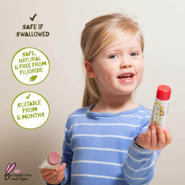 A child using Jack N' Jill Natural Calendula Toothpaste Strawberry Flavor