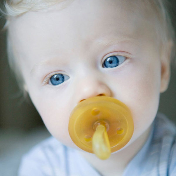 Close up shot of a baby using Natursutten Round Nipple Pacifier