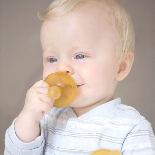 Happy baby using Natursutten Round Nipple Pacifier