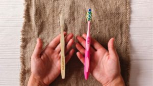 A side by side comparison of a bamboo toothbrush (left) with the conventional plastic toothbrush (right)